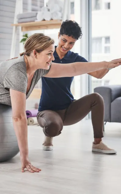 Exercise Therapist helping a client stretch