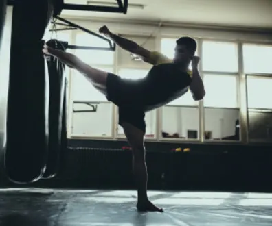 Kickboxing Instructor hitting a punching/kicking bag