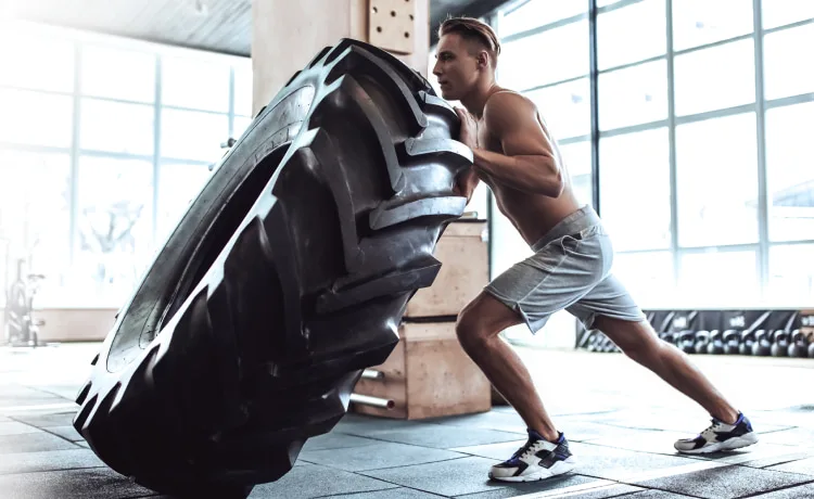 A tactical conditioning specialist pushing a tire